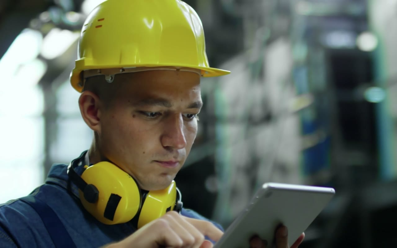 Engineer reviewing equipment data on a tablet
